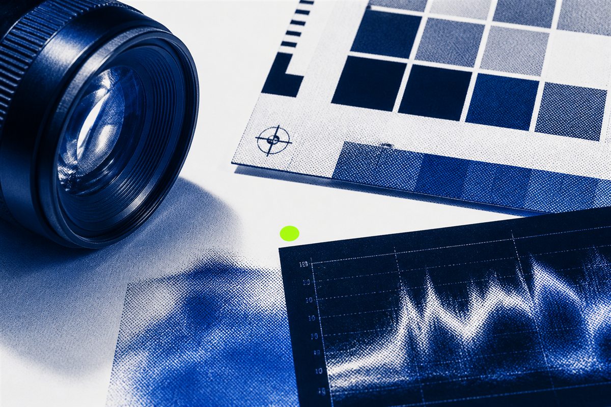 Camera lens, color target, and editing waveform in a cobalt studio still life
